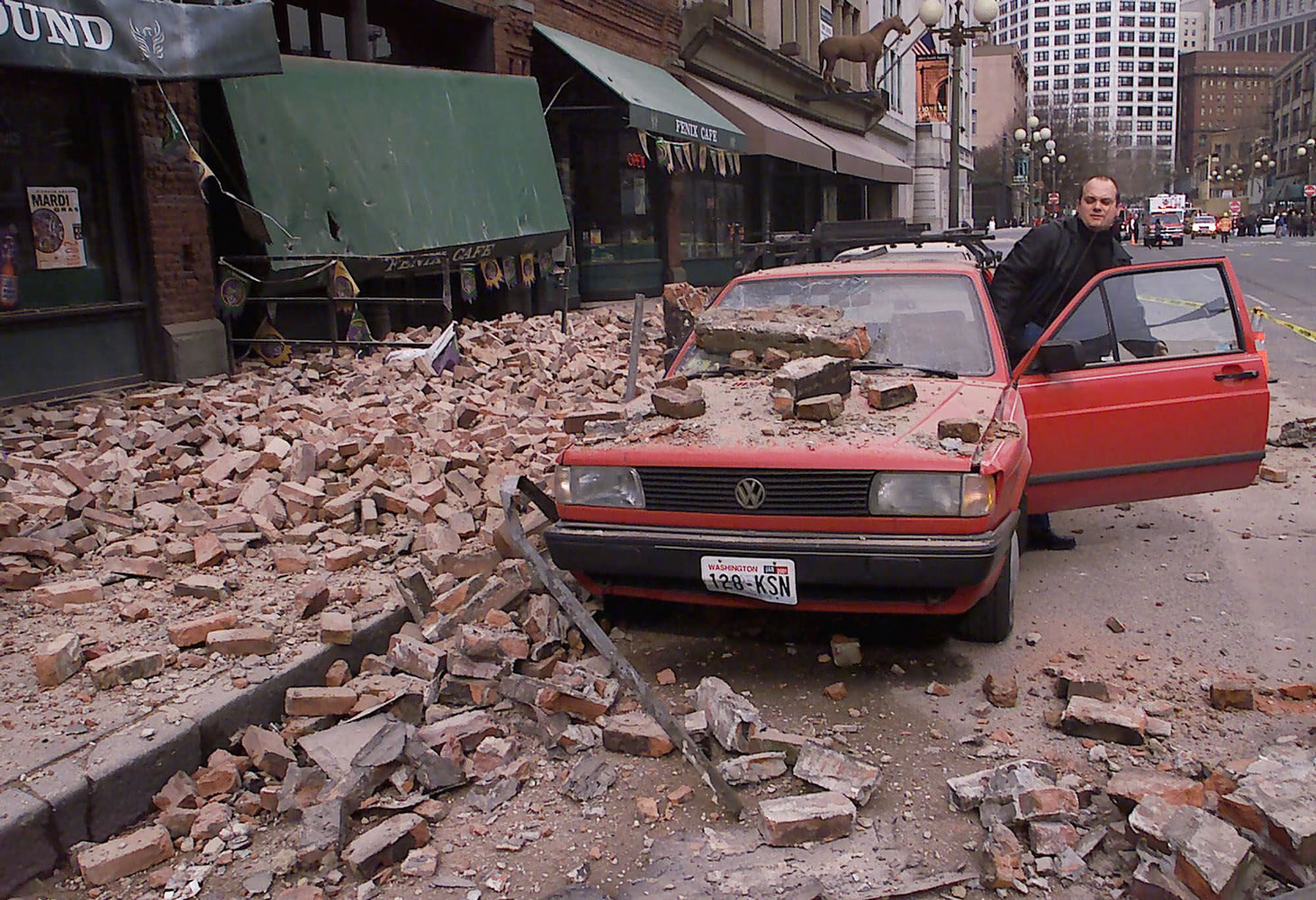 FILES/Associated
Paul Riek checks to see if his car starts after debris fell on it from the top half of a nearby building during the 2001 Nisqually earthquake in Seattle. The 6.8 earthquake caused extensive damage, but earthquakes of that size are not uncommon in the Pacific Northwest.