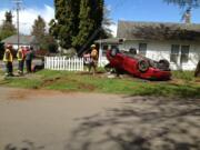 A mother, father and girl were injured when the sedan they were driving rolled over and ended on its top in the yard of a Rose Village residence.