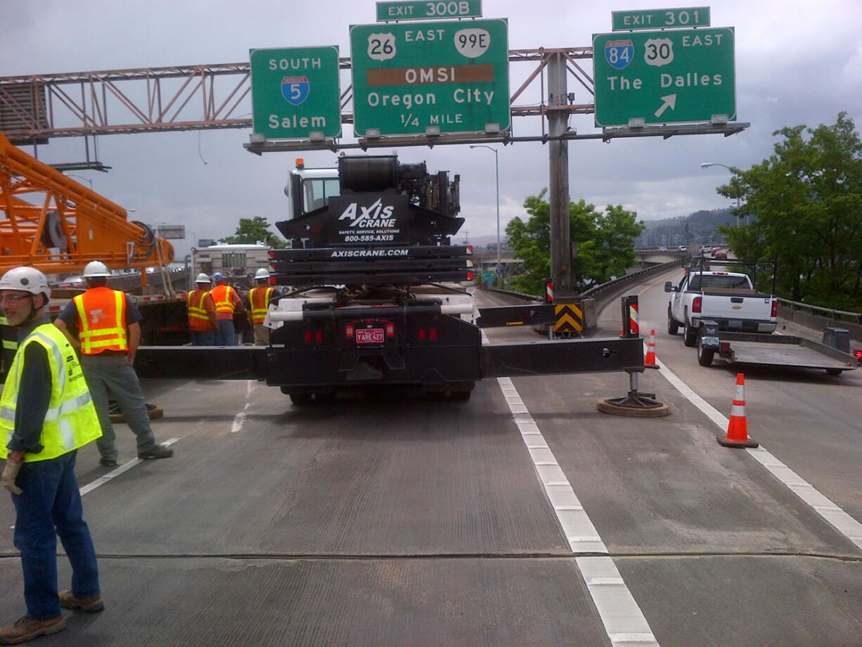 Crews are working to remove a counterweight, a piece of a crane, that fell off a truck and is blocking southbound lanes of Interstate 5.