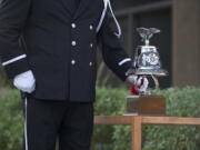 Vancouver Fire Captain Perry LeDoux rings a bell in remembrance of those who lost their lives in the 9/11 attacks during a ceremony at Vancouver City Hall.