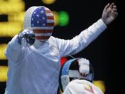 Vancouver's Seth Kelsey, left, competes against Venezuela's Silvio Fernandez during the men's individual epee fencing competition at the 2012 Summer Olympics, Wednesday in London.