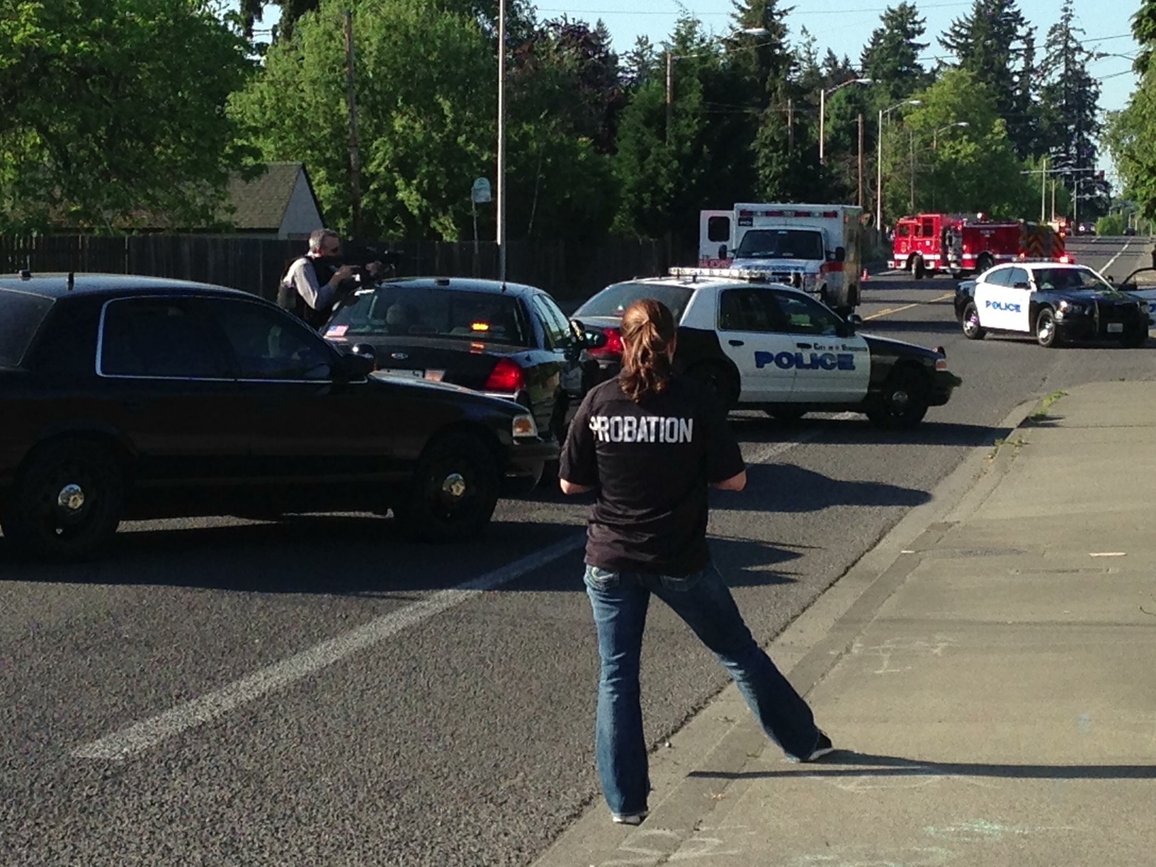 Law enforcement officers take up positions around the scene of a shooting Thursday at 1927 W. 27th St.