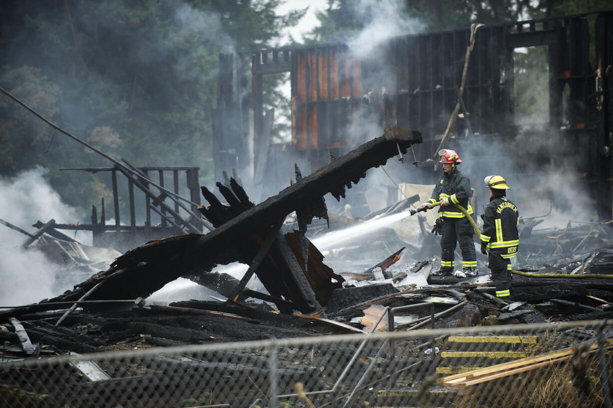 Firefighters douse flames at former Landover Athletic Club Friday morning.