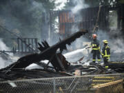 Firefighters douse flames at former Landover Athletic Club Friday morning.