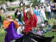 Katya Ponomareva, from the Russian Community Center in Redmond, entertains with a traditional dance at the Russian-American cultural festival in Esther Short Park in 2010.