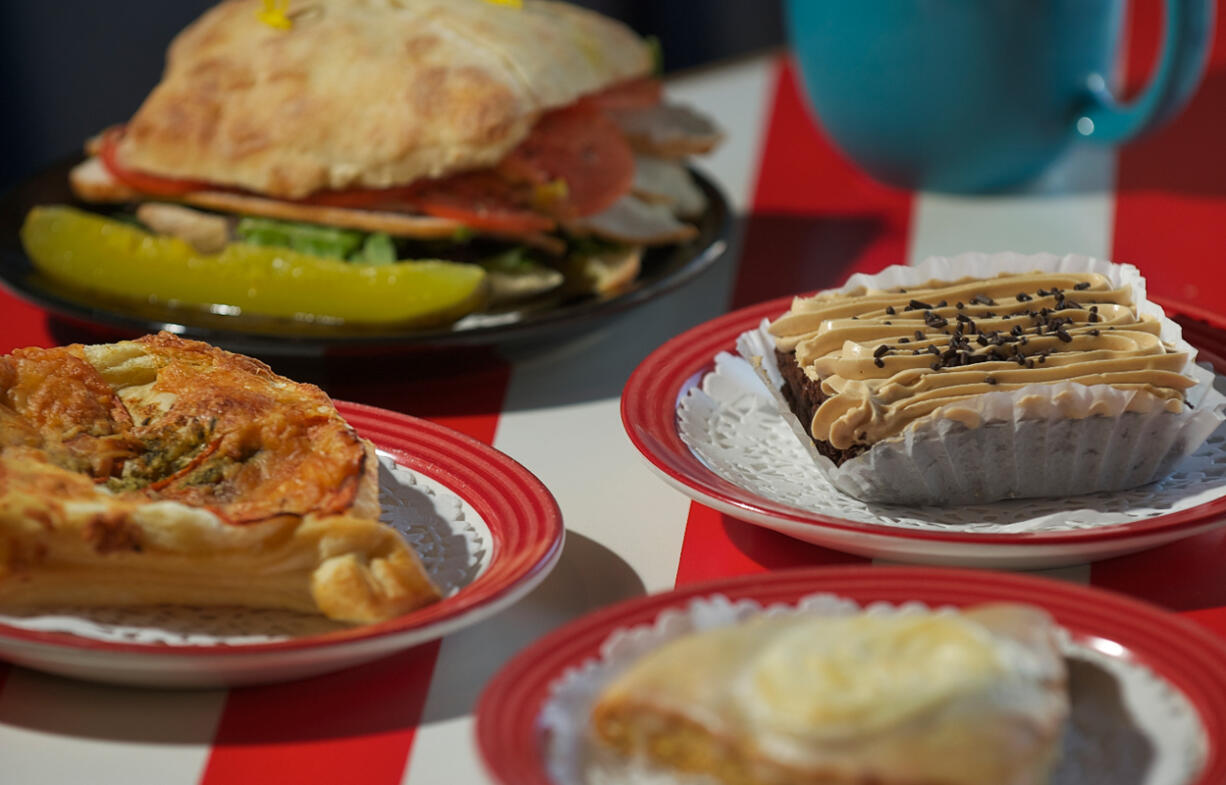 A roasted turkey sandwich on a ciabatta roll with mustard, mixed greens, sliced cucumber, provolone cheese and tomato; tomato/pesto/Parmesan puff pastry, gluten-free brownie and lemon poppyseed scone at Sugar and Salt Bakery.