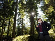 Jessica Walz, conservation director with the Gifford Pinchot Task Force, speaks to a group of reporters as she stands on one of a network of roads to exploratory drilling sites in the area where the Ascot Mining Company wants to do more exploratory drilling above the Green River and on the border of the Mt. St Helens National Volcanic Monument near Randle on Oct.