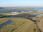 A burned area stretches west from the point where a grass and brush fire kindled Friday east of Washougal. This aerial photo was taken at about 8:30 a.m.