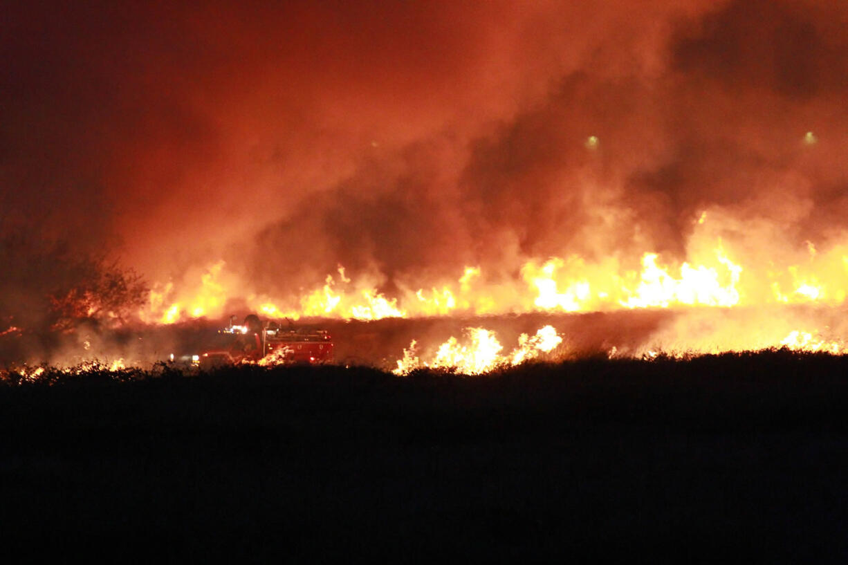 Firefighters work to suppress the brush fire at Steigerwald National Wildlife Refuge near Washougal on Friday.