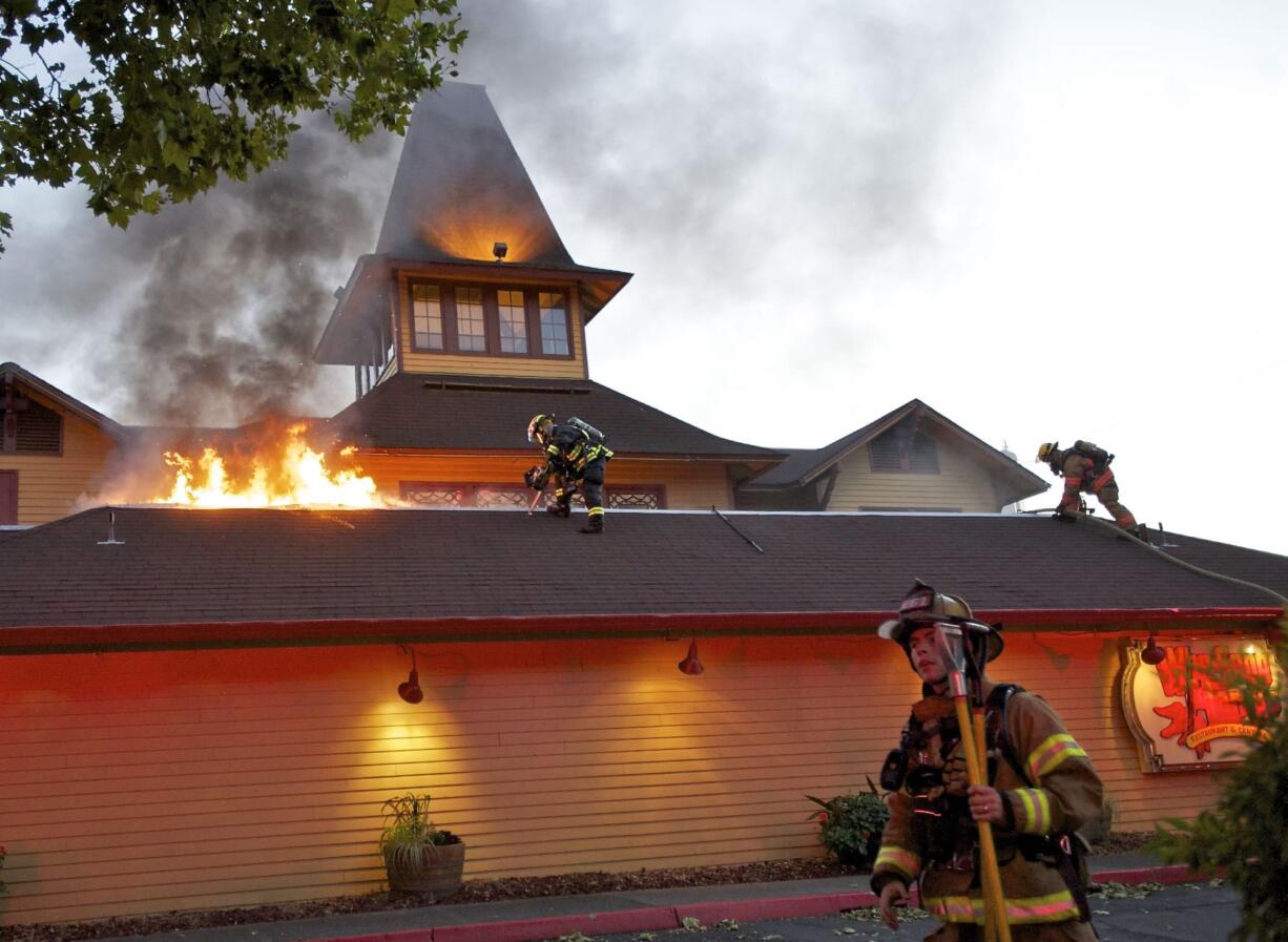 Firefighters respond to Who Song &amp; Larry's Restaurant and Cantina after fire broke out during the dinner rush at the waterfront business on Wednesday.