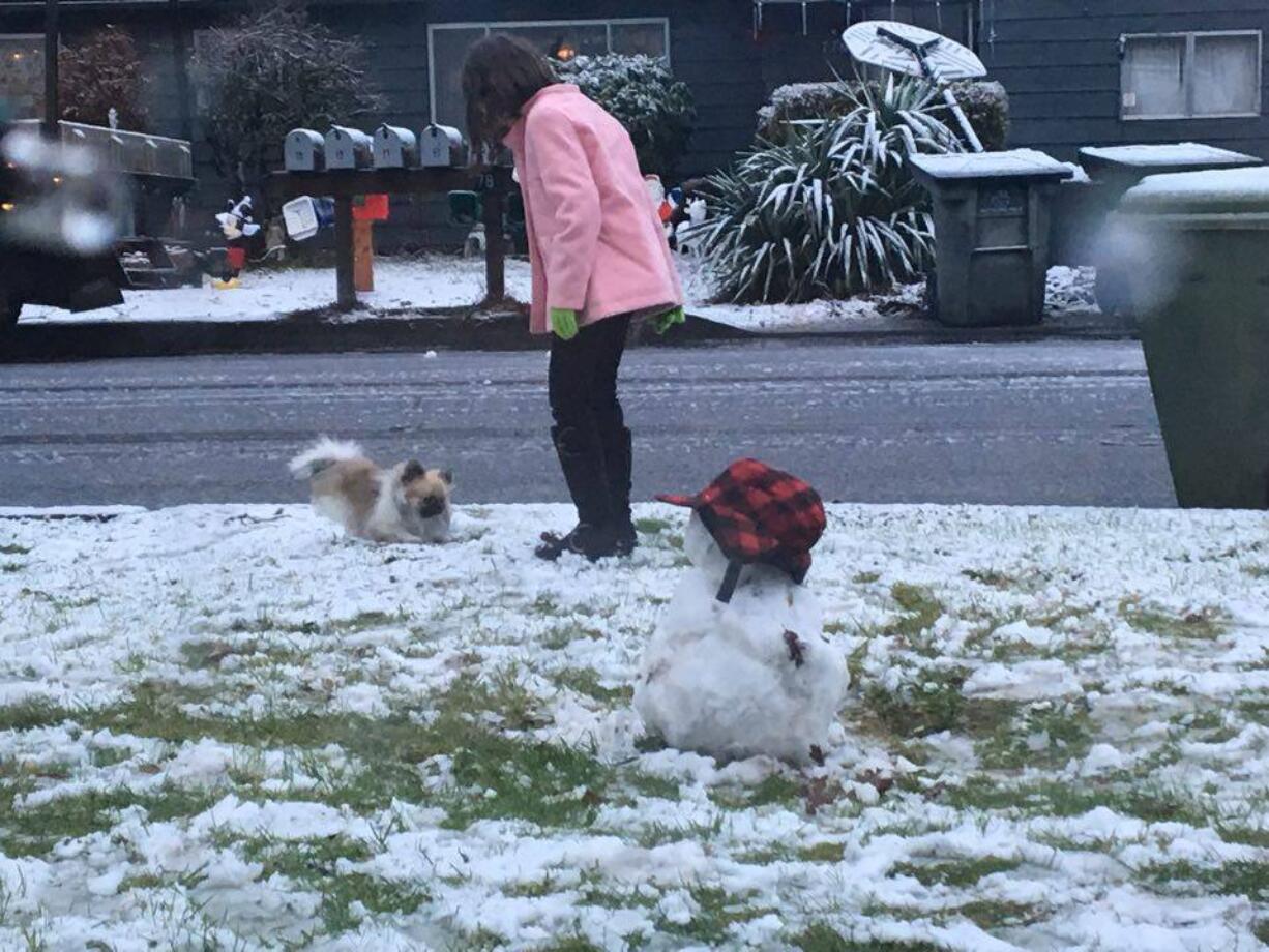 Kids play in the dusting of snow that feel in Woodland on Christmas Eve.