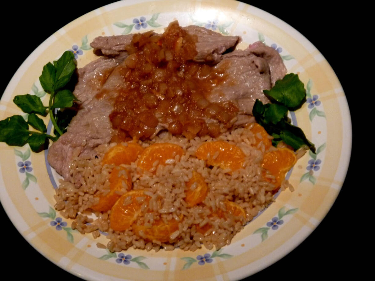 Veal Cutlets in Madeira Sauce with Orange Rice.