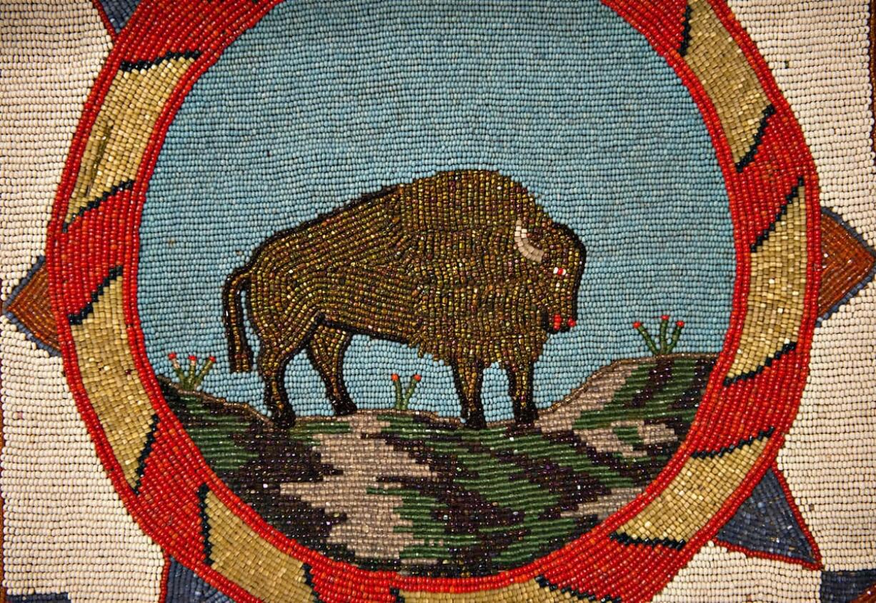 The image of a bison is created by intricate beading on a flat bag made during the 1930s. It is part of a new exhibit at the Clark County Historical Museum in Vancouver. Top: A selection of beaded pouches that date back to the late 1800s are on display at the historical museum.