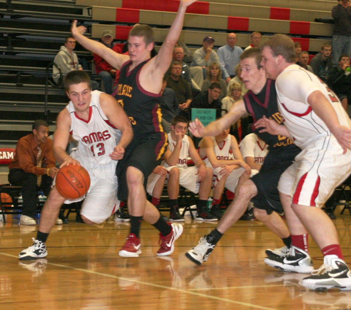 Anthony Fallin (13) curls around a Prairie defender Saturday, at Camas.