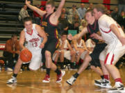 Anthony Fallin (13) curls around a Prairie defender Saturday, at Camas.