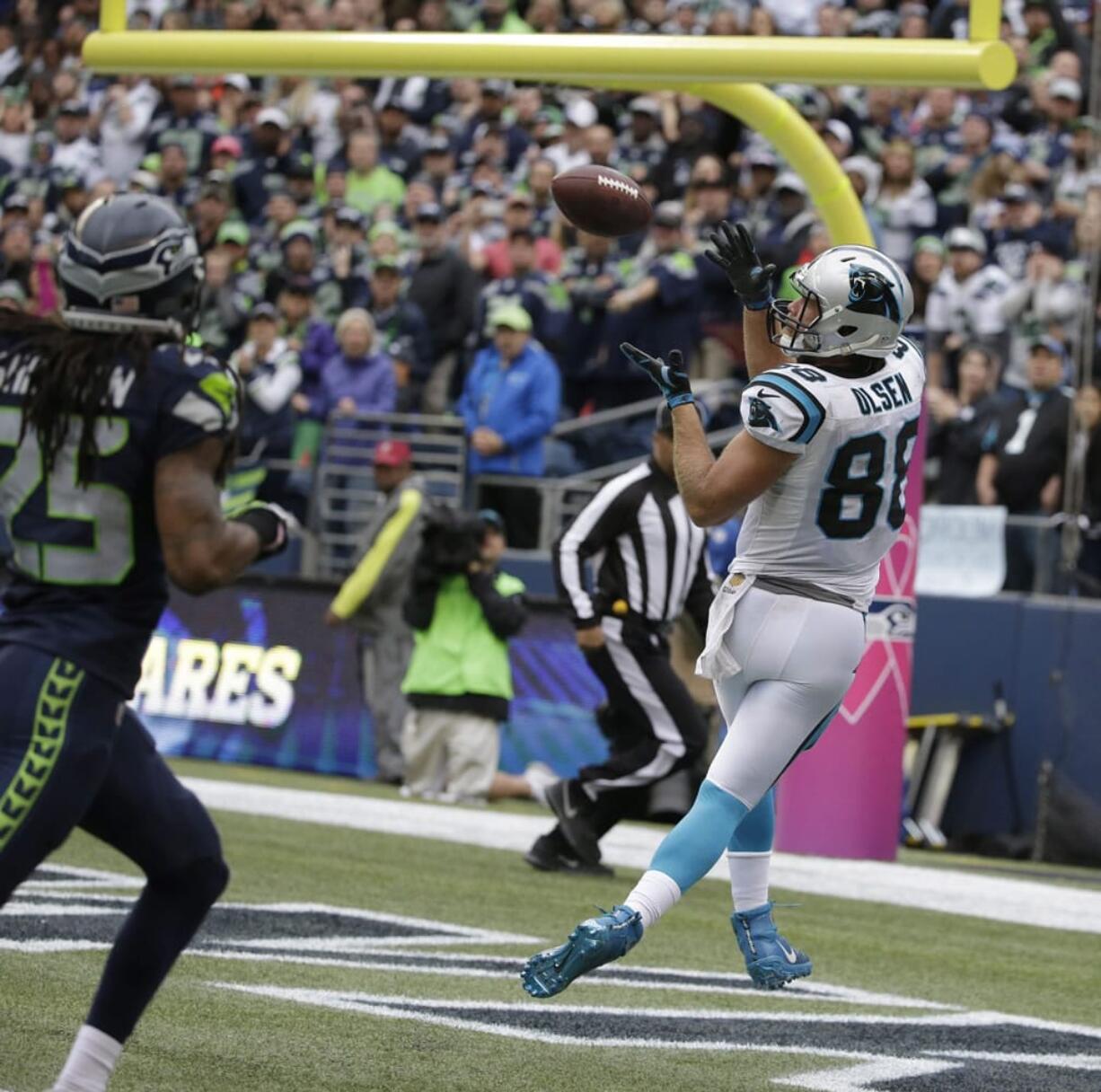 Carolina Panthers tight end Greg Olsen, right, catches a pass for a touchdown ahead of Seattle Seahawks cornerback Richard Sherman, left, in the second half of an NFL football game, Sunday, Oct. 18, 2015, in Seattle.