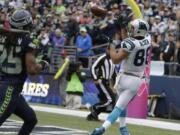 Carolina Panthers tight end Greg Olsen, right, catches a pass for a touchdown ahead of Seattle Seahawks cornerback Richard Sherman, left, in the second half of an NFL football game, Sunday, Oct. 18, 2015, in Seattle.