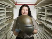 National Park Service employee Heidi Pierson holds a 1918 U.S.