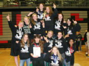 The Panther girls wrestlers stand on the podium