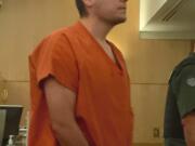 Dmitriy Gernega, 22, appears in Clark County Superior Court on Dec. 11 after robbing a Vancouver Cascade Federal Credit Union branch at gunpoint twice in April 2014. He was sentenced Wednesday to 10 years in prison.