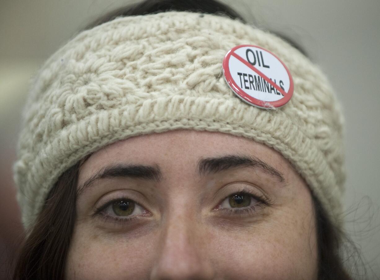 Erin Murdock wears a button indicating her opposition to building an oil transfer terminal, at the first public hearing on the matter Jan. 5 in Vancouver.