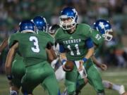 Mountain View's Colin Biggs (11) hands off to teammate Anthony Ramirez (3) in the second quarter Friday night, Oct. 23, 2015 at McKenzie Stadium.