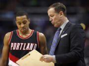 Portland Trail Blazers guard C.J. McCollum (3) watches as head coach Terry Stotts draws a play in the second half of an NBA basketball game against the Washington Wizards, Monday, Jan. 18, 2016, in Washington. The Trail Blazers won 108-98.