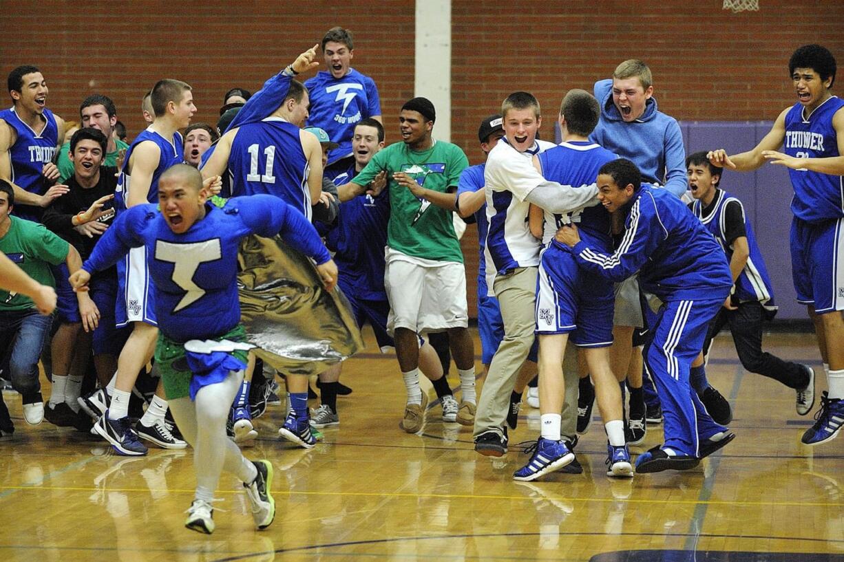 Mountain View players and fans mob Luke DuChesne, right, after the Thunder beat Columbia River 54-53 in overtime on Tuesday night.