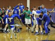 Mountain View players and fans mob Luke DuChesne, right, after the Thunder beat Columbia River 54-53 in overtime on Tuesday night.