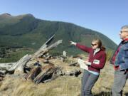 In this 2011 photo, Jessica Walz, with Bob Dingethal, right, both from the Gifford Pinchot Task Force, points to the area where Ascot Resources wants to do exploratory drilling above the Green River and on the border of the Mount St. Helens National Volcanic Monument.