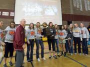 Chuck Thurman stands with the Prairie girls basketball after the Falcons won the 2012 3A state championship.