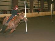 Washougal Equestrian Team President Felicia Harrison leads Tucker between the poles Saturday, in the first District Three WAHSET meet at the Clark County Fairgrounds.