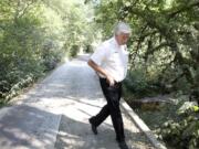 Clark County Fire District 3 Chief Steve Wrightson walks in September on a private bridge in Brush Prairie.