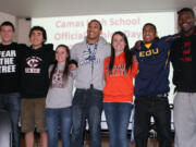 Camas High School seniors Austin Barr, Michael Koceja, Emily Ainsworth, Jonathan Warner, Olivia Lovell, John Payne and Kamari Brown (left to right) smile for the camera on National College Signing Day.