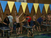 Camas swimmers Nick Kabel, Kasey Calwell and Trent Harimoto (left to right) celebrate with John Utas after they set a new Kelso swimming pool record time of 1 minute, 32.02 seconds in the 200-meter freestyle relay.