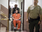 Stephen A. Lubeck, 19, accused of robbery, kidnapping, and assault in connection with the Dec. 2 robbery of the Wells Fargo near Vancouver Mall makes his way to the courtroom for his first appearance at the Clark County Courthouse on Tuesday December 6, 2011.