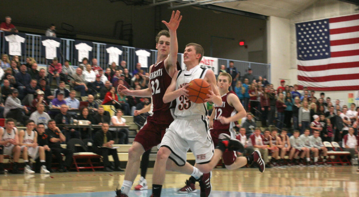 Jaden Jantzer (33) glides to the hoop for two of his 12 points off the bench for the Panthers in the district playoffs Saturday, at Mark Morris High School.