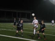 Nate Bealey (21) nudges the ball forward for Camas Monday, at Doc Harris Stadium.