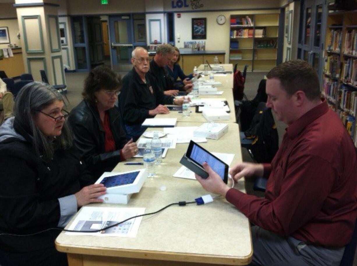 Washougal School Board members receive instruction on their new iPad2 devices from technology director Lester Brown, right.