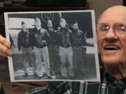 Tom Griffin holds a photo of his B-25 crew -- including a Vancouver airman -- for the April 18, 1942, Doolittle Raid on Japan. Griffin, then a lieutenant, stands at left with, from left, pilot Lt. Harold Watson, Tech. Sgt. Eldred Scott, Lt. James Parker, and Staff Sgt.