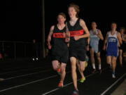 Washougal's Isaac Stinchfield (front) and Sean Eustis (left) push each other in the 3,200-meter run at the Kalama Invitational Friday. Eustis won this event with a time of 9:41.02.