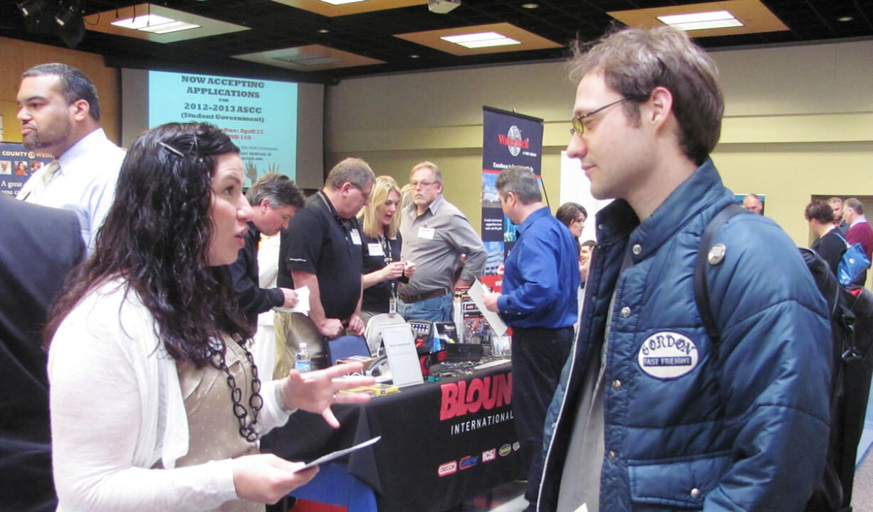 Awna Underwood, the district training leader for Sleep Train Inc., chatted with many individuals Wednesday, at the Clark College &quot;Career Days&quot; job fair. Recruiters from 46 companies and military personnel were available to answer questions posed by more than 800 job fair attendees. Underwood, of Camas, said Sleep Train is hiring for full time entry level sales positions.