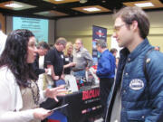 Awna Underwood, the district training leader for Sleep Train Inc., chatted with many individuals Wednesday, at the Clark College &quot;Career Days&quot; job fair. Recruiters from 46 companies and military personnel were available to answer questions posed by more than 800 job fair attendees. Underwood, of Camas, said Sleep Train is hiring for full time entry level sales positions.