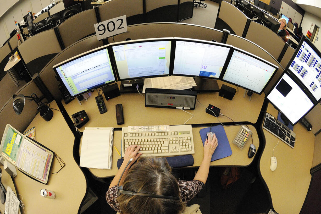 Jolee Mercer, a veteran dispatcher with CRESA for 17 years, works the county sheriff calls, which also includes BNSF, Camas police, Washougal police, Ridgefield police, La Center police, Battle Ground police at the CRESA office May 24, 2011 in Vancouver, Washington.