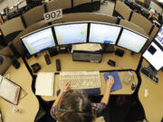 Jolee Mercer, a veteran dispatcher with CRESA for 17 years, works the county sheriff calls, which also includes BNSF, Camas police, Washougal police, Ridgefield police, La Center police, Battle Ground police at the CRESA office May 24, 2011 in Vancouver, Washington.