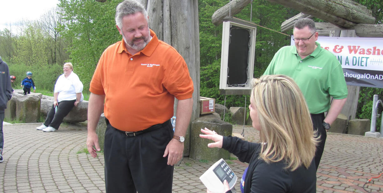 Washougal Mayor Sean Guard gets weighed in, as Fat 2 Fit NW Executive Director Michelle Clark and Camas Mayor Scott Higgins look on, during the May 2 kickoff of the &quot;Camas and Washougal on a Diet&quot; challenge. Since then, Guard has lost 7.5 pounds, while Higgins has lost 9 pounds. &quot;It is going well,&quot; Higgins said Monday.