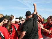 The Papermaker softball players and coaches celebrate after beating Kelso 2-1 Monday, at Camas High School, to clinch their first league championship since 2002.