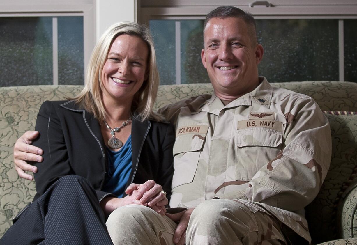 Lori Volkman poses for a portrait with her husband Cdr. Randy Volkman inside their Ridgefield home in March.