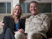 Lori Volkman poses for a portrait with her husband Cdr. Randy Volkman inside their Ridgefield home in March.