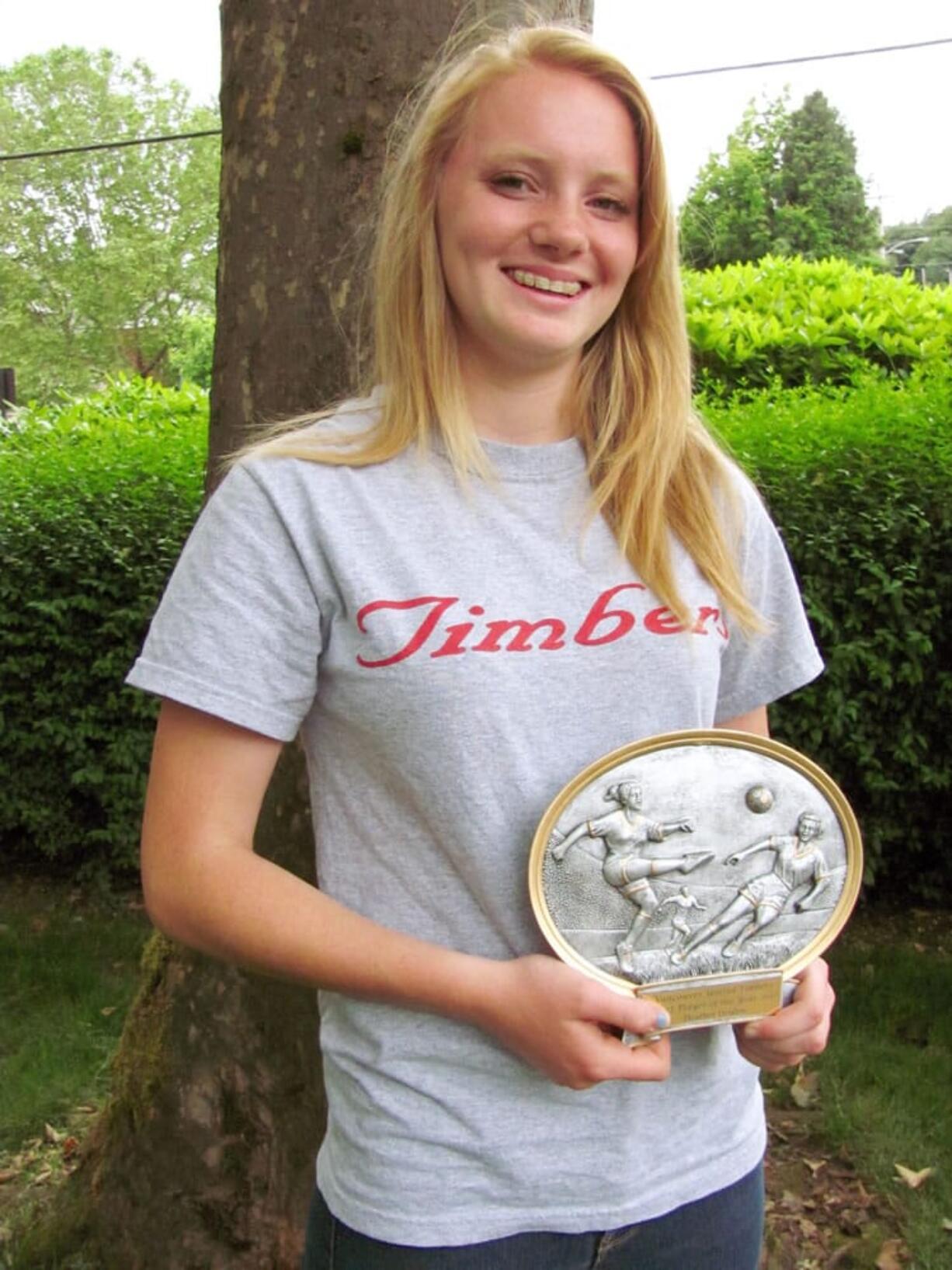 Heather Deuhlen proudly holds her Vancouver United Soccer Alliance Player of the Year award.